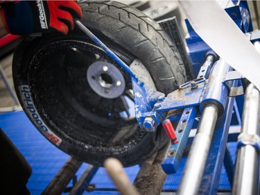For the first time ever the Red Bull Global Rallycross made a Canadian stop over the weekend at the Canada Aviation and Space Museum. A tire gets it's seal broken so it can be pulled off the rim and changed in the BFGoodrich area Sunday June 18, 2017.   Ashley Fraser/Postmedia
Ashley Fraser, Postmedia