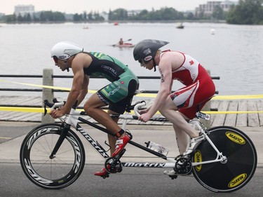 David Blair, right, winner of the visually impaired paratriathlon, takes part in the Ottawa International Triathlon in Ottawa on Sunday, June 18, 2017.