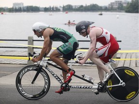 Participants in the Ottawa International Triathlon, including  David Blair, right, winner of the visually impaired paratriathlon, battled the heat Sunday. Expect more hot muggy weather on Monday.