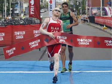 David Blair wins the visually impaired paratriathlon at the Ottawa International Triathlon in Ottawa on Sunday, June 18, 2017.