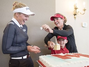 LPGA Tour player, Brooke Henderson, left, reacts to Lorie Kane trying to put some icing on her nose while Zander Zatylny, the CP Women's Open Child Ambassador, looks on during media event to promote the CP Women's Open, an LPGA Tour event in Ottawa Aug. 24-27, at the Ottawa Hunt and Golf Club Wednesday June 21, 2017. (Darren Brown/Postmedia)  NEG: 126848
Darren Brown, Postmedia