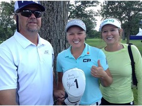 Dave, Brooke and Brittany Henderson with Brooke's driver head cover signed by Phil Mickelson. Brooke Henderson competed against Mickelson in a skills competition at the KPMG Women's PGA Championship on Monday.