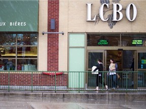 Shoppers leave LCBO on Wellington Street West Sunday after stocking up in case there is a strike by liquor store employees.