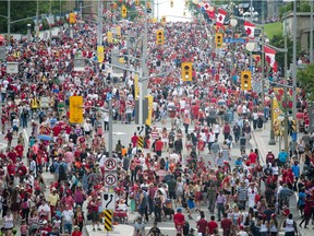 Canada Day revellers make their way up and down Rideau Street where the sinkhole was downtown Ottawa Friday July 1, 2016.
