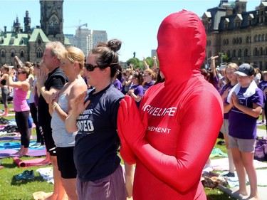 Coinciding with construction, yoga and over 165 students bringing attention to elder abuse, Canadian Blood Services were also out on Parliament's lawn for World Blood Donor Day, testing people's blood type and bringing attention to the need for blood donation.  Dressed as the lifeblood mascot, The Morph, Annie Barrette, stood out amidst the yoga practitioners in her all-red suit.