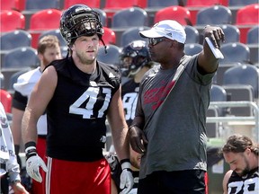 Defensive line coach, Leroy Blugh (right), talks with DE Arnaud Gascon-Nadon during Ottawa Redblacks practice at TD Place Wednesday (June 21, 2017).