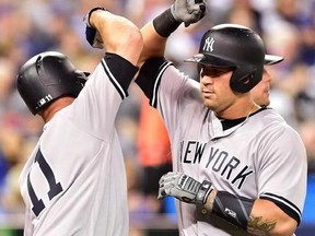 New York Yankees outfielder Brett Gardner (11) congratulates Yankees catcher Gary Sanchez (24) on his two-run home run against the Toronto Blue Jays during fourth inning MLB American League baseball action in Toronto, Thursday, June 1, 2017.