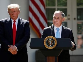 In this June 1, 2017, photo, President Donald Trump listens as EPA Administrator Scott Pruitt speaks about the U.S. role in the Paris climate change accord in the Rose Garden of the White House in Washington. Trump‚Äôs environmental chief has been trying to clear the air about why his boss is pulling out of the Paris climate accord, but some of the claims he‚Äôs making are as solid as smoke. (AP Photo/Pablo Martinez Monsivais)
