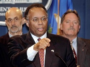 FILE - In this Oct. 17, 2002 file photo Deputy Attorney General Larry Thompson, center, talks with reporters in Washington, United States. At left, Michael Chertoff, then head of the Justice Department&#039;s Criminal Division, and FBI Deputy Director Bruce Gebhardt, right, listen. Thompson the independent monitor overseeing Volkswagen&#039;s efforts to prevent a repeat of its emissions scandal says he has a &ampquot;broad mandate&ampquot; to review the company&#039;s practices and that his initial impression is that VW is ma