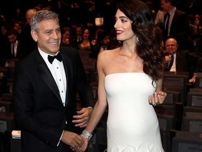 In this Feb. 24, 2017 file photo, actor George Clooney, left, and Amal Clooney arrive at the 42nd Cesar Film Awards ceremony at Salle Pleyel in Paris. George and Amal Clooney have welcomed twins Ella and Alexander Clooney. The pair was born Tuesday morning, June 6, 2017, according to George Clooney's publicist.