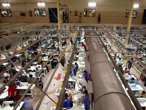 FILE - This Feb. 2, 2005, file photo shows Bangladeshi workers at a textile factory on the outskirts of Dhaka, Bangladesh. The European Union has slapped new security screening on imports from Bangladesh Wednesday, June 7, 2017, a move that is likely to make it costlier for businesses in the South Asian country to sell products to EU nations. (AP Photo/Manish Swarup, File)