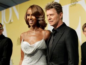 FILE - In this June 6, 2005, file photo, singer David Bowie and his wife Iman pose at the 2005 CFDA Fashion Awards in New York. Iman remembered the late singer with a social media post on June 6, 2017, which would have been their 25th wedding anniversary. (AP Photo/Stuart Ramson, File)