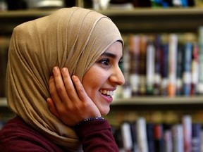 In this June 1, 2017, photo Israa Enan wears a stylish hijab during an interview at Deering High School in Portland, Maine. Enan, who recently graduated, admitted she shied away from going out for high school sports teams because of the embarrassment she would have felt if her stylish scarf fell off during competition. (AP Photo/Robert F. Bukaty)