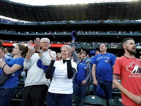 Toronto Blue Jays fans cheer at the end of the singing of the Canadian national anthem at Safeco Field before the Blue Jays&#039; baseball game against the Seattle Mariners, Saturday, June 10, 2017, in Seattle. Blue Jays games in Seattle traditionally draw large numbers of visiting team fans due to Seattle&#039;s proximity to Canada. (AP Photo/Ted S. Warren)