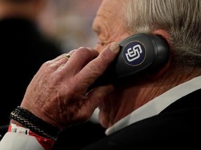 Former professional baseball player Randy Jones talks on the phone as he represents the San Diego Padres prior to the start of the Major League Baseball draft, Monday, June 12, 2017, in Secaucus, N.J.(AP Photo/Julio Cortez)