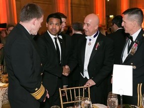 In this March 15, 2014, photo provided by Alfredo Flores, from left, Vice Admiral Michael Rogers; Paul Monteiro, vice chairman and co-Founder of Nowruz Commission; Bijan R. Kian and Lt. Gen. Michael Flynn talk during the Fifth Annual Nowruz Commission Gala at the Andrew W. Mellon Auditorium in Washington. As Michael Flynn spent last fall campaigning as Donald Trump‚Äôs top national security adviser, Bijan Kian, his little-known business partner supervised much of the foreign political work for T