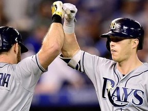 Tampa Bay Rays designated hitter Corey Dickerson (10) celebrates his solo home run with teammate Evan Longoria (3) during ninth inning American League baseball action against the Toronto Blue Jays, in Toronto, Tuesday, June 13, 2017.