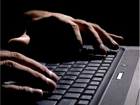 male hands on the keyboard,low key and high contrast,may suggest cyber cryme, hacking,spying