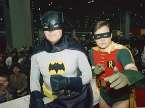 FILE - In this Jan. 27, 1989, file photo, actors Adam West, left, and Burt Ward, dressed as their characters Batman and Robin, pose for a photo at the &ampquot;World of Wheels&ampquot; custom car show in Chicago. Los Angeles Mayor Eric Garcetti says the Bat-Signal will shine over the city on Thursday, June 15, 2017 in tribute to West, who died June 9 at the age of 88. (AP Photo/Mark Elias, File)