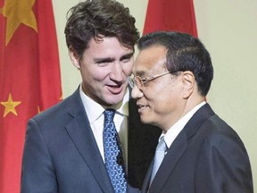 Canadian Prime Minister Justin Trudeau, left, introduces Chinese Premier Li Keqiang after speaking to a business luncheon, Friday, September 23, 2016 in Montreal. Canada and China have agreed not to engage in state-sponsored hacking of each other&#039;s trade secrets and business information. THE CANADIAN PRESS/Ryan Remiorz