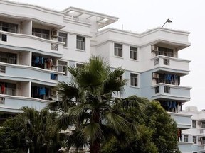 In this June 18, 2017, photo, workers&#039; clothes hang on the balcony of a company-owned apartment adjacent to a shoe factory owned by the Huajian Group, which has made shoes for the Ivanka Trump brand, in Ganzhou in southern China&#039;s Jiangxi Province. Chinese who have worked at the factory, that also makes shoes for other brands, say they‚Äôve faced 16-hour days, low pay and verbal abuse.