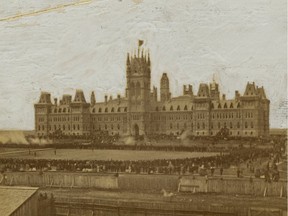 The scene captured by early Ottawa photographer Elihu Spencer on July 1, 1867, birthday of the Dominion of Canada, showing the firing of the noon-hour "feu de joie" — a "fire of joy" gun salute — by a rifle regiment on the grounds in front of the original Parliament Buildings.