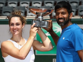 PARIS, FRANCE - JUNE 08:  Gabriela Dabrowski of Canada and Rohan Bopanna of India celebrate with the trophy following victory in the mixed doubles final against Anna-Lena Groenefeld of Germany and Robert Farah of Columbia on day twelve of the 2017 French Open at Roland Garros on June 8, 2017 in Paris, France.