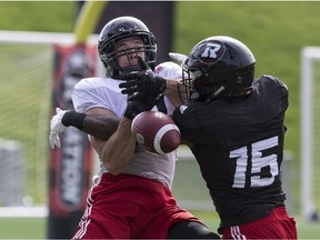 Jake Harty, left, battles for a reception against the coverage of defensive back Keelan Johnson during a Redblacks training-camp workout on May 30. Errol McGihon/Postmedia