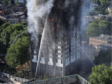 Fire fighters tackle the building after a huge fire engulfed the 24 story Grenfell Tower in Latimer Road, West London in the early hours of this morning on June 14, 2017 in London, England.  The Mayor of London, Sadiq Khan, has declared the fire a major incident as more than 200 firefighters are still tackling the blaze, while at least 30 people are receiving hospital treatment.