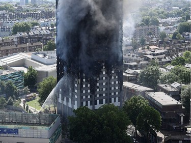 Fire fighters drench the burning 24 storey residential Grenfell Tower block in Latimer Road, West London on June 14, 2017 in London, England.  The Mayor of London, Sadiq Khan, has declared the fire a major incident as more than 200 firefighters are still tackling the blaze while at least 50 people are receiving hospital treatment.