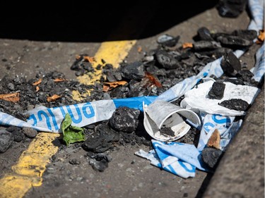 Police tape lies among burnt material near to the burning 24 storey residential Grenfell Tower block in Latimer Road, West London on June 14, 2017 in London, England. The Mayor of London, Sadiq Khan, has declared the fire a major incident as more than 200 firefighters are still tackling the blaze while at least six are dead and 20 are in critical care.