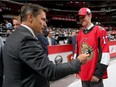 Fourth-round draft pick Drake Batherson meets Senators head coach Guy Boucher at the United Center in Chicago on Saturday.  Bruce Bennett/Getty Images