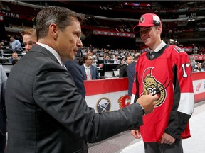 Fourth-round draft pick Drake Batherson meets Senators head coach Guy Boucher at the United Center in Chicago on Saturday.  Bruce Bennett/Getty Images