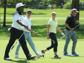 (L-R) Former NFL star Bo Jackson, John Veihmeyer, Chairman of KPMG International, Brooke Henderson of Canada and former MLB pitcher Greg Maddux stroll up a fairway during the pro-am  prior to the start of the 2017 KPMG Women's PGA Championship at Olympia Fields Country Club on June 27, 2017 in Olympia Fields, Illinois.