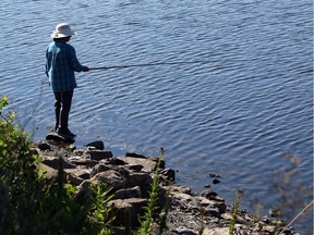 A woman enjoys her fishing on the Ottawa River.