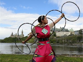 Hoop dancer Sarah Decontie practises as part of Tourism Week with Aboriginal Experiences on Victoria Island below Parliament Hill recently. THE CANADIAN PRESS/Fred Chartrand ORG XMIT: FXC104 Fred Chartrand,
