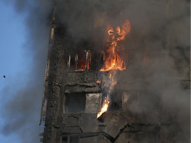 Fire rips through Grenfell Tower as firefighters attempt to control a huge blaze on June 14, 2017 in west London.  The massive fire ripped through the 27-storey apartment block in west London in the early hours of Wednesday, trapping residents inside as 200 firefighters battled the blaze. Police and fire services attempted to evacuate the concrete block and said "a number of people are being treated for a range of injuries", including at least two for smoke inhalation.