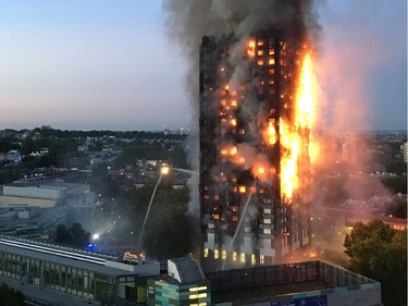 This handout image received by local resident Natalie Oxford early on June 14, 2017 shows flames and smoke coming from a 27-storey block of flats after a fire broke out in west London. The fire brigade said 40 fire engines and 200 firefighters had been called to the blaze in Grenfell Tower, which has 120 flats.