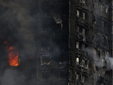 Smoke and flames billow from Grenfell Tower, a residential block on June 14, 2017 in west London.  The massive fire ripped through the 27-storey apartment block in west London in the early hours of Wednesday, trapping residents inside as 200 firefighters battled the blaze. Police and fire services attempted to evacuate the concrete block and said "a number of people are being treated for a range of injuries", including at least two for smoke inhalation.