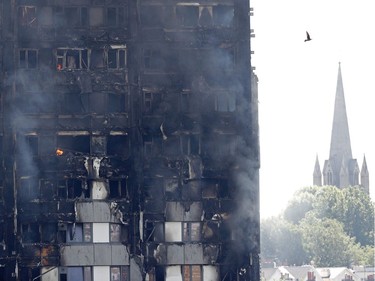 Flames and smoke engulf Grenfell Tower, a residential block on June 14, 2017 in west London.  Shaken survivors of a blaze that ravaged a west London tower block told Wednesday of seeing people trapped or jump to their doom as flames raced towards the building's upper floors and smoke filled the corridors.