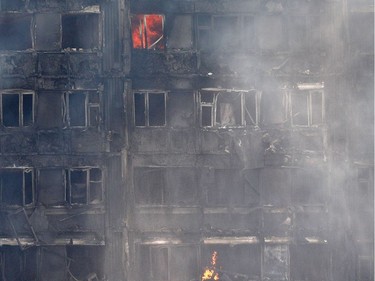 Flames and smoke engulf Grenfell Tower, a residential block on June 14, 2017 in west London.  Shaken survivors of a blaze that ravaged a west London tower block told Wednesday of seeing people trapped or jump to their doom as flames raced towards the building's upper floors and smoke filled the corridors.