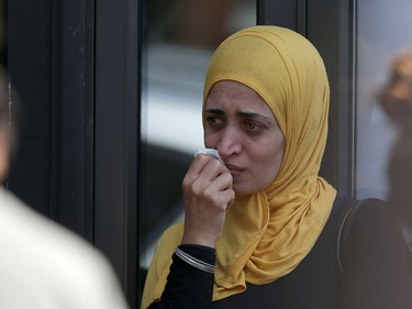 A woman reacts outside a temporary casualty bureau for people affected by the fire at Grenfell Tower, a residential block of flats on June 14, 2017 in west London, as firefighters continue to control a fire. Shaken survivors of a blaze that ravaged a west London tower block told Wednesday of seeing people trapped or jump to their doom as flames raced towards the building's upper floors and smoke filled the corridors.