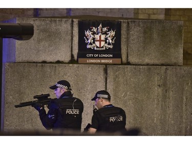 An armed officer looks through his weapon on London Bridge.