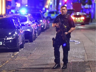 An armed police stands on Borough High Street as police are dealing with an incident on London Bridge in London, Saturday, June 3, 2017.    Witnesses reported a vehicle hitting pedestrians and injured people on the ground. (Dominic Lipinski/PA via AP) ORG XMIT: LON884