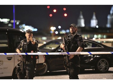 Armed officers stand guard on London Bridge.