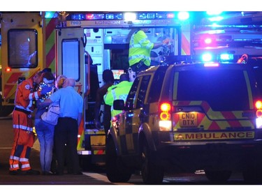 Members of the emergency services attend to persons injured in an apparent terror attack on London Bridge.