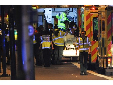 Police officers and members of the emergency services attend to a person injured in an apparent terror attack.