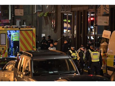 Police and members of the emergency services work at the scene of a terror attack near London Bridge.