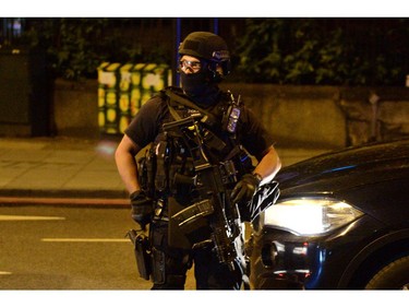 Armed police officers arrive at the scene of a terror attack.