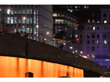 An emergency response helicopter lands on London Bridge.